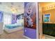 Frozen themed bedroom with ensuite bathroom, bed, and ceiling fan at 1507 Carey Palm Cir, Kissimmee, FL 34747