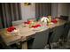 Formal dining room features a long table set for six, with gray chairs and modern decor at 1507 Carey Palm Cir, Kissimmee, FL 34747