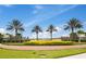 Beautifully landscaped community entrance with SOLARA RESORT sign and palm trees at 1507 Carey Palm Cir, Kissimmee, FL 34747