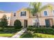 Well-maintained townhome with lush landscaping, healthy lawn, and classic architectural details at 1507 Carey Palm Cir, Kissimmee, FL 34747