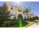 Charming two-story home featuring lush landscaping and a well-manicured front yard at 1507 Carey Palm Cir, Kissimmee, FL 34747