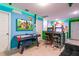 Fun game room featuring air hockey table and arcade games, accented with Nintendo themed wall art and cool lighting at 1507 Carey Palm Cir, Kissimmee, FL 34747