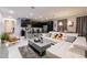 Open-concept living area with modern furnishings, a kitchen, and sleek decor at 1507 Carey Palm Cir, Kissimmee, FL 34747