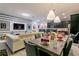 Well-decorated living and dining area, complete with a table set for a dinner party at 1507 Carey Palm Cir, Kissimmee, FL 34747