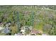 Aerial view showing expansive lot with the in-ground pool and mature trees offering privacy at 1606 Wildcat Ct, Winter Springs, FL 32708