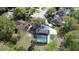 Aerial view of the landscaped backyard featuring a screened-in pool and fire pit area, ideal for outdoor enjoyment at 1606 Wildcat Ct, Winter Springs, FL 32708