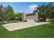 Large backyard with a basketball hoop, oversized garage, screened-in pool, and ample parking space at 1606 Wildcat Ct, Winter Springs, FL 32708