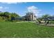 Expansive backyard with screened pool, fire pit, and lush green lawn perfect for entertaining and relaxation at 1606 Wildcat Ct, Winter Springs, FL 32708