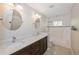 Well-lit bathroom showcasing double sinks with granite counters and a shower-tub combo at 1606 Wildcat Ct, Winter Springs, FL 32708