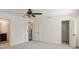 Spacious carpeted bedroom showcasing a closet, access to bathroom and a ceiling fan at 1606 Wildcat Ct, Winter Springs, FL 32708