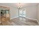 Formal dining room with stylish flooring, elegant chandelier, and view of the bright sunroom through French doors at 1606 Wildcat Ct, Winter Springs, FL 32708