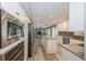 Bright kitchen with stainless steel appliances, white cabinetry and long island with wood floors throughout at 1606 Wildcat Ct, Winter Springs, FL 32708