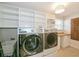 Functional laundry room with modern appliances and plenty of storage shelving at 1606 Wildcat Ct, Winter Springs, FL 32708