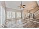 Bright living room with vaulted ceilings, modern flooring, plantation shutters, and stylish lighting at 1606 Wildcat Ct, Winter Springs, FL 32708