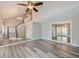 Spacious living room featuring modern flooring, a staircase, and an open doorway to another room at 1606 Wildcat Ct, Winter Springs, FL 32708