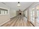 Open living room with brick fireplace, built-in shelving, ceiling fan, and luxury vinyl plank floors at 1606 Wildcat Ct, Winter Springs, FL 32708
