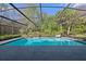 Enjoy a refreshing swim in this screened-in pool with a scenic backdrop of trees and nature at 1606 Wildcat Ct, Winter Springs, FL 32708