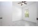 Bright bedroom featuring a ceiling fan, neutral paint, large window, and tile flooring at 16893 Sw 17Th Ter, Ocala, FL 34473