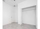 Bedroom features tile flooring, closet with shelving, and neutral paint at 16893 Sw 17Th Ter, Ocala, FL 34473