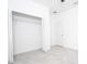 Bedroom features tile flooring, closet with shelving, and neutral paint at 16893 Sw 17Th Ter, Ocala, FL 34473