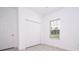 Bright bedroom features a window, closet, tile flooring, and neutral paint at 16893 Sw 17Th Ter, Ocala, FL 34473