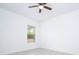 Bright bedroom featuring tile floors, a ceiling fan and a window at 16893 Sw 17Th Ter, Ocala, FL 34473