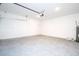 Open garage area with a clean concrete floor, white walls, and water heater at 16893 Sw 17Th Ter, Ocala, FL 34473