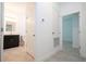 Hallway view leading to bathroom and bedroom with neutral paint and tile floors at 16893 Sw 17Th Ter, Ocala, FL 34473