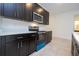 Sleek kitchen with dark cabinets, stainless steel appliances, and a quartz countertop at 16893 Sw 17Th Ter, Ocala, FL 34473