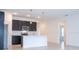 Modern kitchen featuring stainless steel appliances, dark cabinets, and a white island with a breakfast bar at 16893 Sw 17Th Ter, Ocala, FL 34473