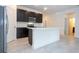 Well-designed kitchen with dark wood cabinets, a white island, and stainless steel appliances at 16893 Sw 17Th Ter, Ocala, FL 34473