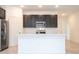 Modern kitchen featuring a large island, stainless steel appliances, and dark cabinetry at 16893 Sw 17Th Ter, Ocala, FL 34473