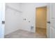 Bright laundry room with white walls, tile floors, storage shelf, and washer/dryer hookups at 16893 Sw 17Th Ter, Ocala, FL 34473