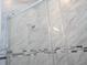 Close-up of a glass-enclosed shower with marble tile at 16893 Sw 17Th Ter, Ocala, FL 34473