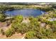 Stunning aerial shot reveals a private estate nestled by a serene lake and lush greenery at 19715 Eaglesview Cir, Umatilla, FL 32784