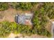 Private home offers a screened-in pool, circular driveway, and mature landscaping from above at 19715 Eaglesview Cir, Umatilla, FL 32784