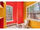 Bright bathroom with natural light, featuring a toilet, windows, and unique color accents at 19715 Eaglesview Cir, Umatilla, FL 32784