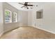 Bedroom featuring tile floors, ceiling fan, and arched windows providing plenty of natural light at 19715 Eaglesview Cir, Umatilla, FL 32784