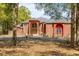 Elegant brick home boasts a striking arched entryway, manicured landscaping, and a circular driveway at 19715 Eaglesview Cir, Umatilla, FL 32784