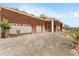 Spacious three-car garage featuring white doors and ample parking space on a concrete driveway at 19715 Eaglesview Cir, Umatilla, FL 32784