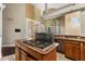 Kitchen island features wooden cabinets and a cooktop with a marble countertop at 19715 Eaglesview Cir, Umatilla, FL 32784