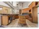 Kitchen with wood cabinetry, island cooktop, tile flooring, and open layout at 19715 Eaglesview Cir, Umatilla, FL 32784