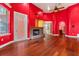 Spacious living room featuring hardwood floors, a ceiling fan, and a brick fireplace at 19715 Eaglesview Cir, Umatilla, FL 32784