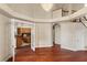 Spacious living room featuring hardwood floors, open entrance to kitchen, and a grand chandelier at 19715 Eaglesview Cir, Umatilla, FL 32784