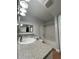 Well-lit bathroom with a shower-tub combo, a granite countertop, and a stylish mirror at 202 E South St # 3050, Orlando, FL 32801