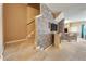 Open-concept living room with modern stone accent wall, a staircase, a fireplace, and bar seating at 2080 Switch Grass Cir, Ocoee, FL 34761