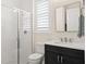 Bathroom featuring a glass-enclosed shower, white subway tiles, and sleek black vanity at 2116 Limestone Trl, Kissimmee, FL 34747