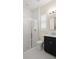 Bathroom featuring a glass-enclosed shower, white subway tiles, and sleek black vanity at 2116 Limestone Trl, Kissimmee, FL 34747