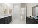 Bathroom with a long vanity and an open doorway leading to the hallway at 2116 Limestone Trl, Kissimmee, FL 34747