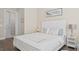 Bedroom with wood flooring, neutral decor, and view into the bathroom at 2116 Limestone Trl, Kissimmee, FL 34747